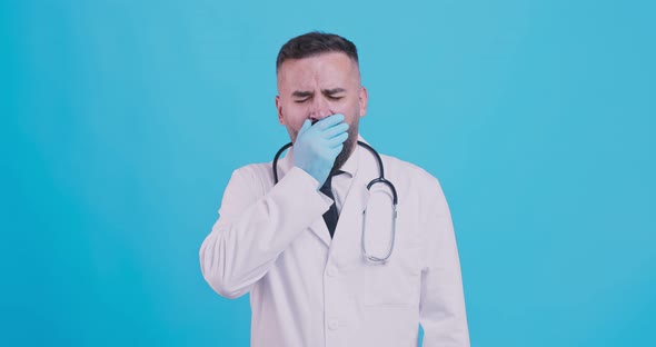 Sleepy Expression. Studio Portrait of Tired Medical Doctor Yawning at Camera