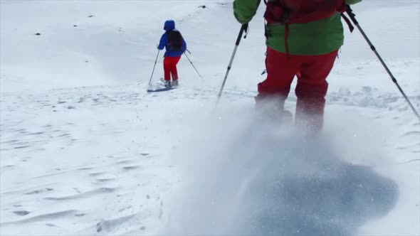 POV tracking shot of skiing on snow covered mountains.