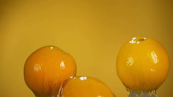 Three Ripe Oranges are Bouncing From the Water with the Beautiful Splashes