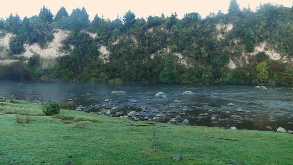 Early Morning at River with Rocky and Lush Nature, Pan Right