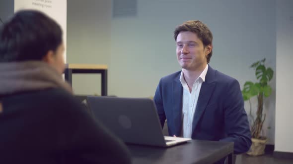 Young Professional Bank Employee Talking with Client Give Advice About Taxes