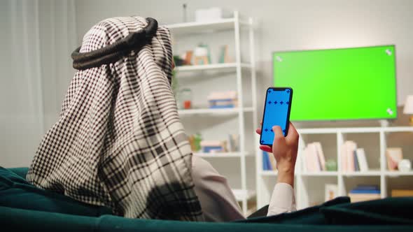 Middle Eastern Man Using Phone with Chroma Key Closeup alt