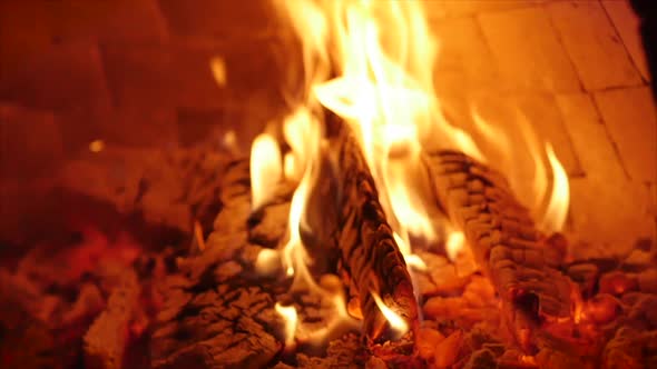 Wood Burns Beautifully in a Pizza Oven. Placing Pizza in a Wood-burning Pizza Oven Using Pizza Rind.