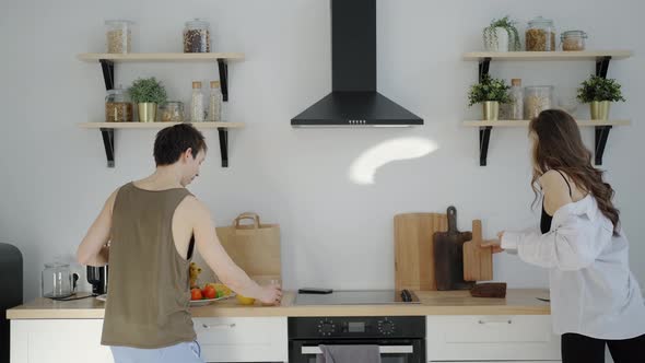 Woman Prepare Breakfast and Her Funny Boyfriend Dancing Around Her