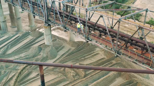 Massive Metal Construction with Two Engineers in the Quarry Zone