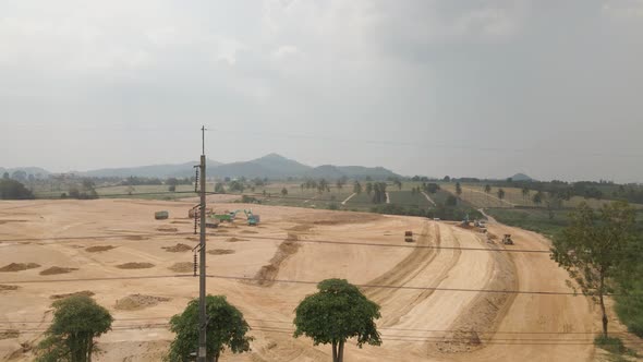 Heavy machinery working on Construction site, Dirt field being prepare to infrastructure, Aerial vie