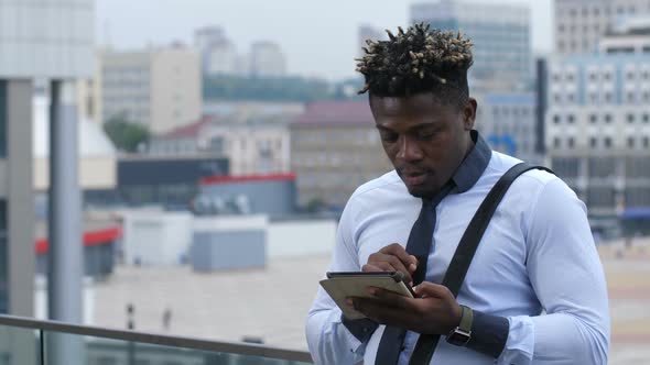 Handsome Businessman Networking with Tablet Device