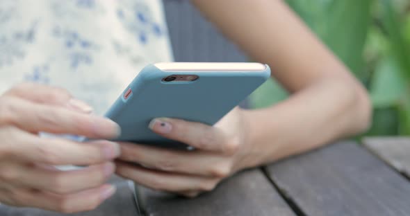 Hands Texting on Smartphone in Cafe