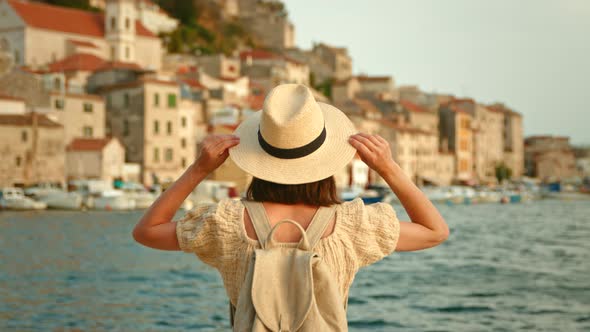 Young tourist looking at the sea on vacation, slow motion