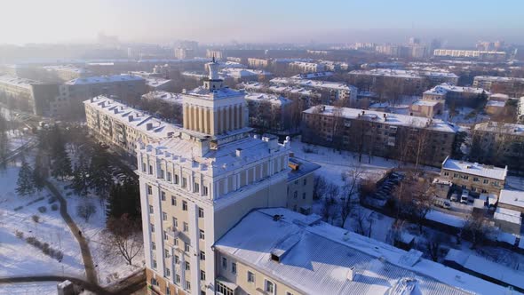 Elegant Tower with Spire on Snowy Classic Building Roof