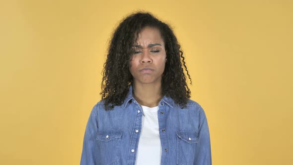 Sad Upset African Girl Isolated on Yellow Background