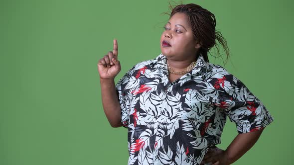 Overweight Beautiful African Woman Against Green Background