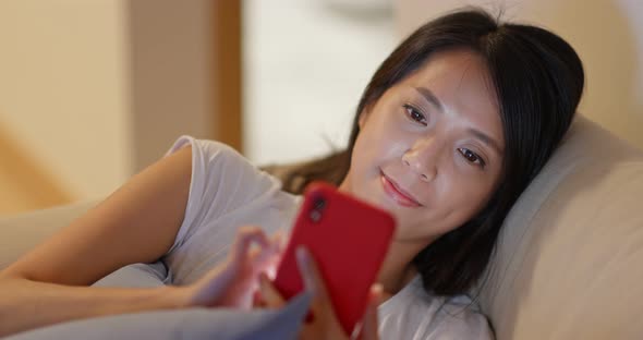 Woman work on cellphone at night