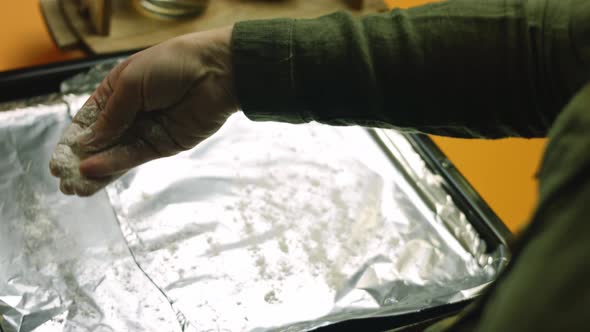 Press Flour on the Baking Tray with Aluminum Foil