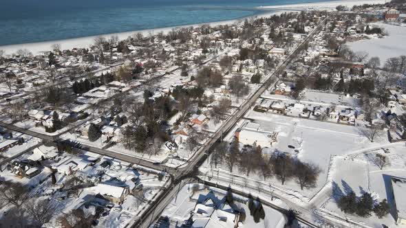 Flying over suburban neighbourhood in winter, St. Catharines, Ontario, Canada, Looking towards Lake
