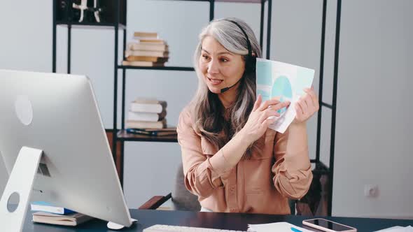 Asian Woman Working Remotely Showing Analysis