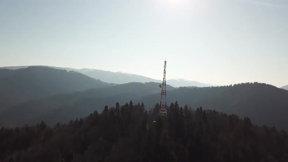 Aerial footage of Communication tower during morning sunrise with clouds.