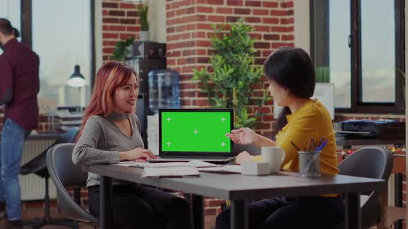 Asian Women Analyzing Green Screen on Computer in Office