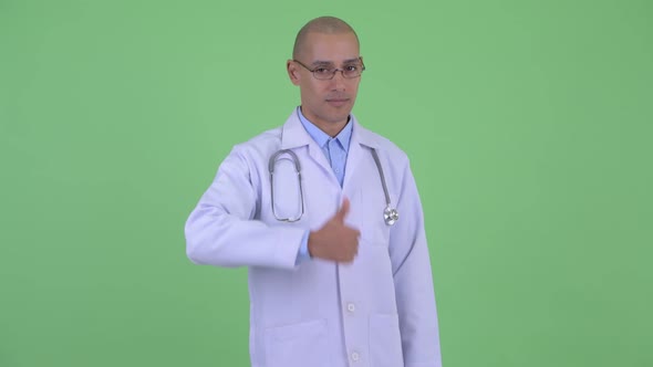 Happy Bald Multi Ethnic Man Doctor Giving Thumbs Up