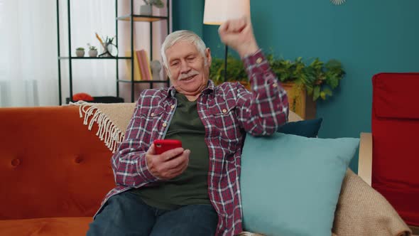 Senior Grandfather Use Mobile Cell Phone Online Shopping Found Out Great Big Win Celebrate at Home