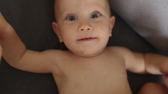 Portrait Funny Blue Eyed Naked Baby Infant Smiling Laughing Looking at Camera