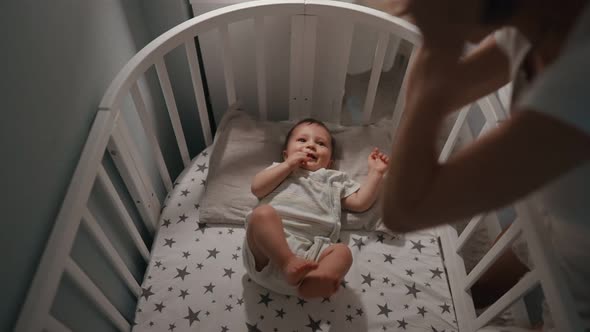 Mother Puts the Baby to Sleepnewborn Baby Mother Puts in Cradle to Sleep and Covers with Blanket