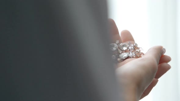 Girl Hands Holding and Touching Wedding Earrings Jewellery. Closeup