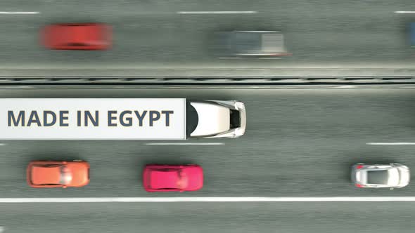 Trucks with MADE IN EGYPT Text Driving Along the Road