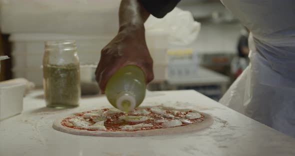 Mixed race man making a pizza