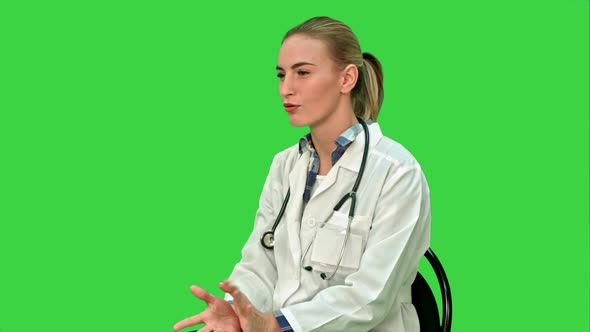 Doctor Have a Positive Conversation with a Patient, Sitting on a Green Screen