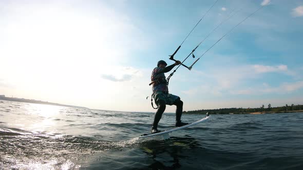 Male Athlete Kite Surfing on River.