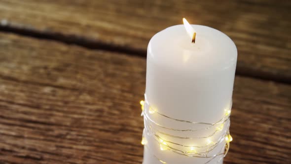 Burning candles on wooden table