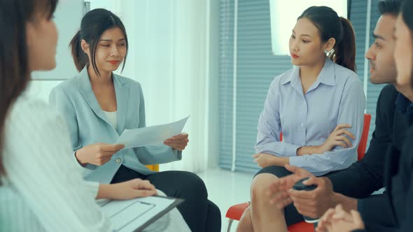 Business People Proficiently Discuss Work Project While Sitting in Circle