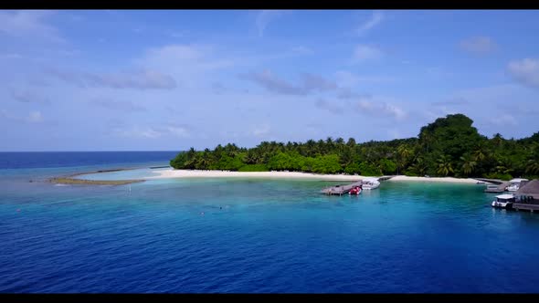 Aerial top down seascape of tranquil seashore beach vacation by blue water with white sand backgroun