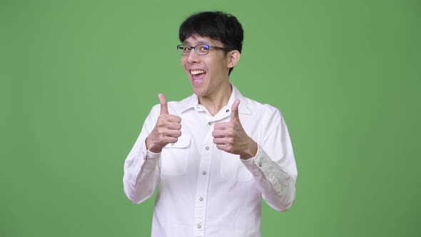 Young Asian Businessman Excited While Giving Thumbs Up