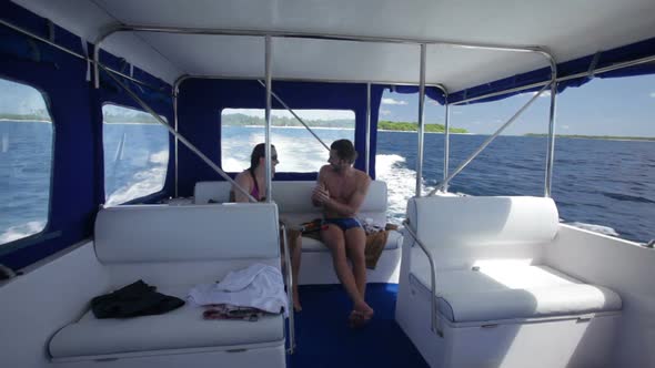 Young Couple in Swim Suits Travelling by Speed Boat