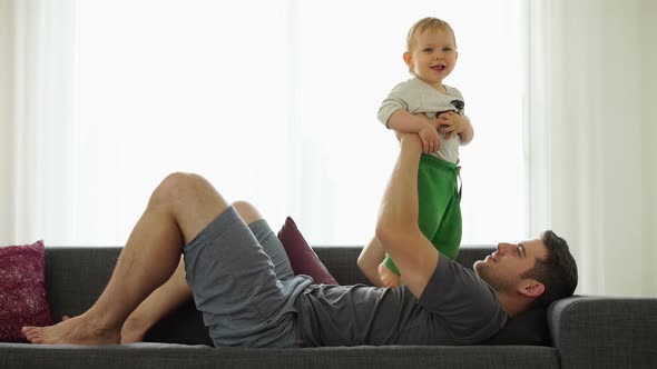 Happy Baby Boy With Dad on Couch