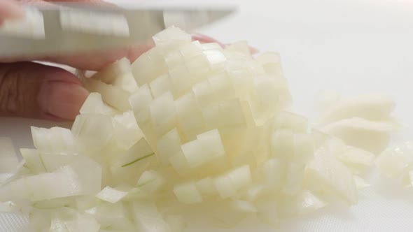 Common bulb onion chopping up with knife 4K 2160p 30fps UHD footage - Close-up Allium cepa vegetable