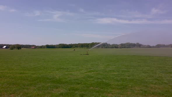 Watering an agricultural field with water sprinkler in area the Achterhoek in the Netherlands