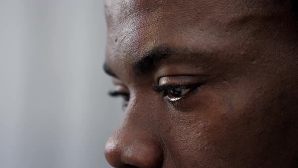 Close Up Eyes African American Businessman Looks at Quotes in Financial Markets