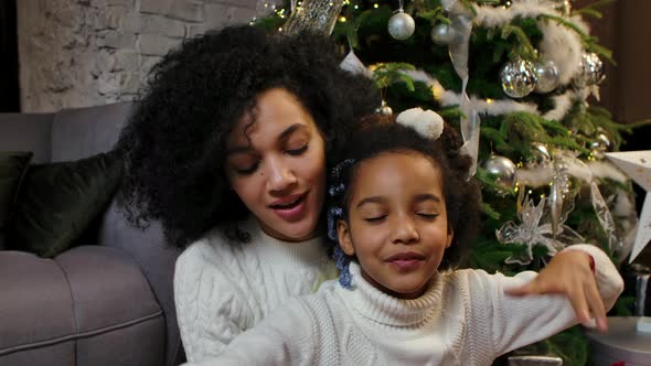 Portrait of Happy Smiling African American Mom and Little Daughter Wishing Merry Christmas and Happy