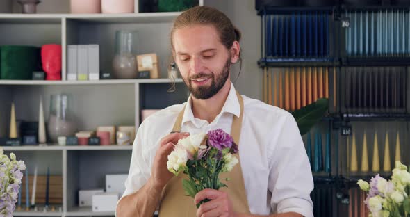 Portrait of Smiling Man Looking at Camera Standing at Workplace.