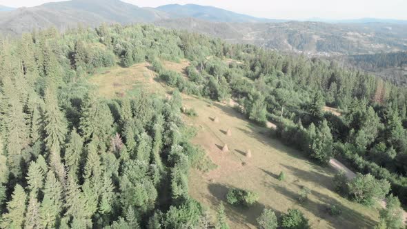 Mountain hills with meadows and haystacks