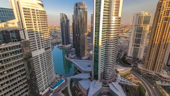 Top View of Buildings Jumeirah Lakes Towers with Traffic on the Road Sunset Timelapse