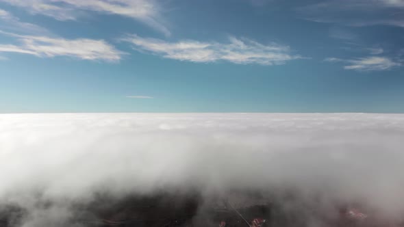 Beautiful Flight Above the Clouds Over the Volcanic Valley