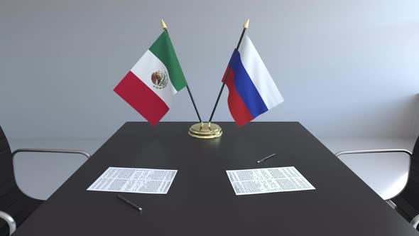 Flags of Mexico and Russia and Papers