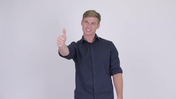 Happy Young Handsome Blonde Businessman Giving Thumbs Up