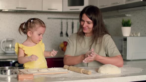 Cheerful Mother and Daughter for 2 Years Preparing Pastries From Dough and Flour at Home