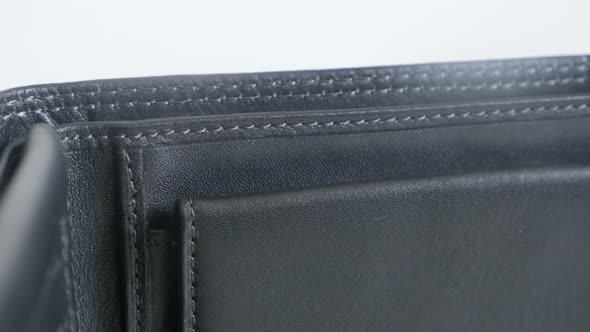 Tilting over  leather wallet on white background   3840X2160 UltraHD footage - Bi-fold black money c