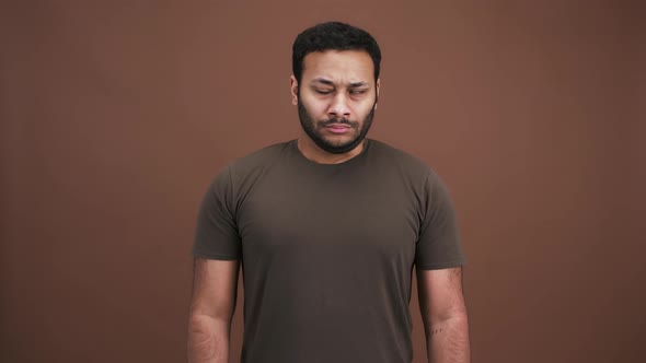 Grumpy Indian Man Looking Around and Folding His Arms Feeling Sad and Offended Brown Studio